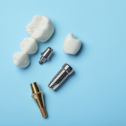 False dentures sitting on a table while a dentist works
