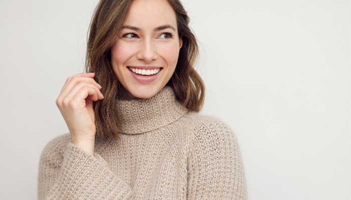 Close up of woman in sweater smiling