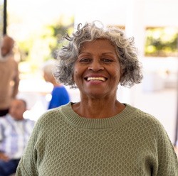 Senior woman smiling with her friends in the background