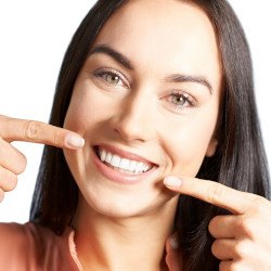 Woman pointing to her teeth