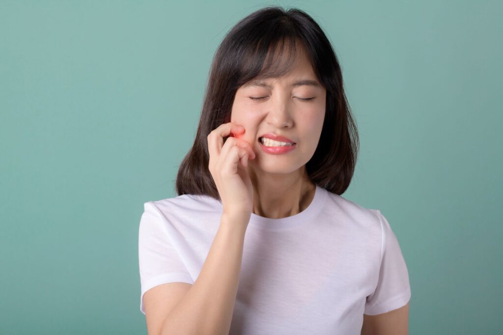 A woman with a loose dental implant